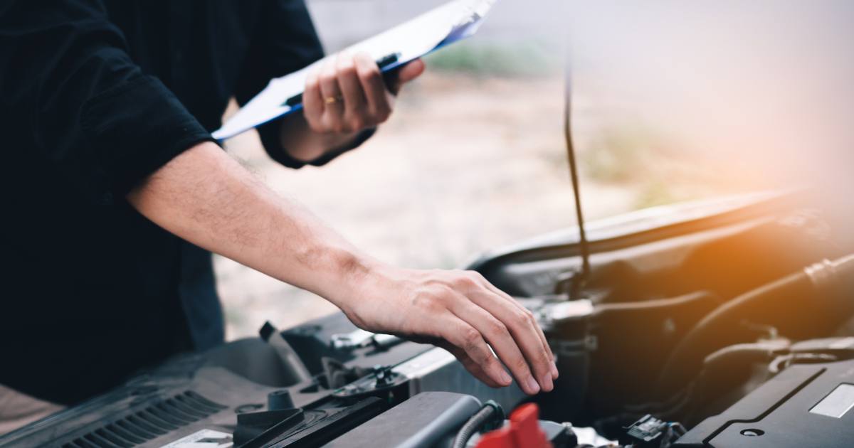 Title loan agent inspecting a vehicle