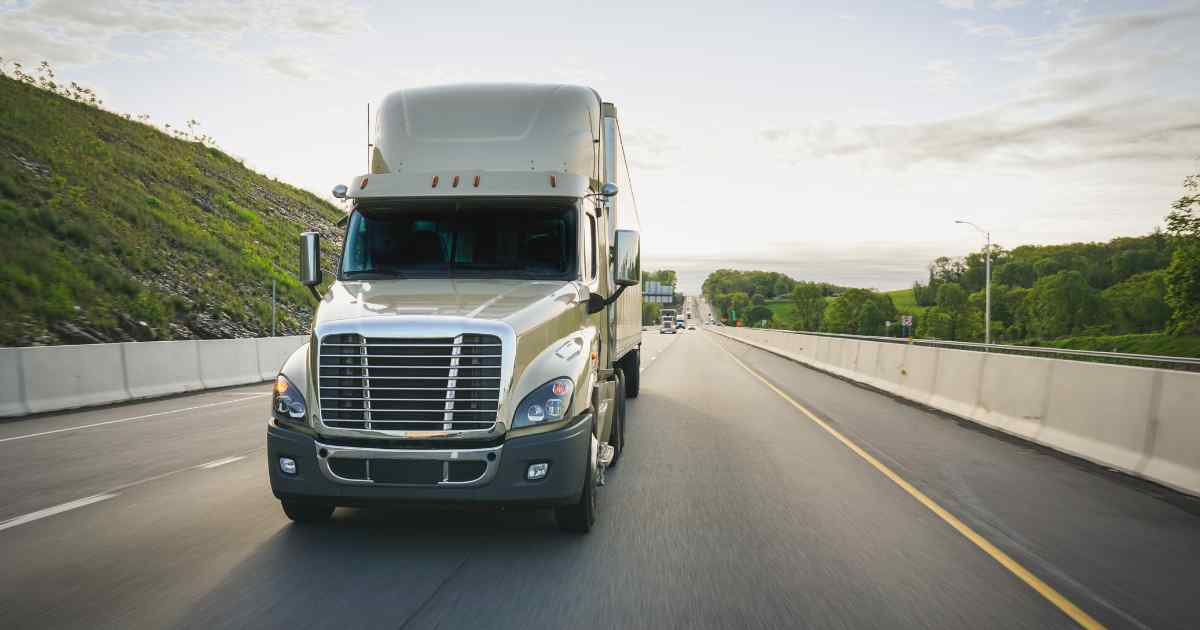 An 18 wheeler traveling on the highway.